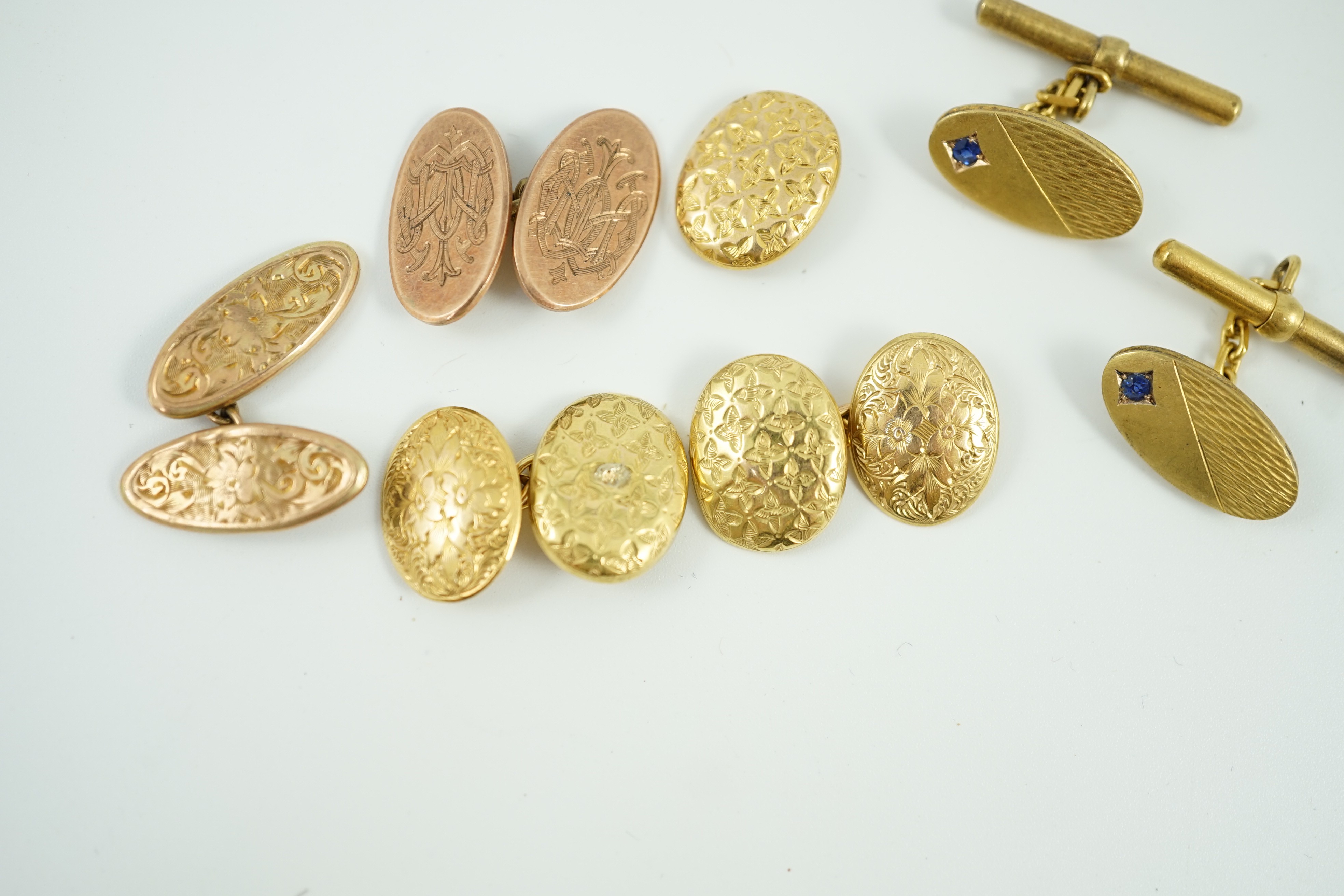 A pair of late Victorian engraved 15ct gold oval cufflinks, one other similar link section only, 6.7 grams, a pair of gem set 585 cufflinks, gross 6.5 grams and two 9ct gold cufflinks, 5.9 grams.